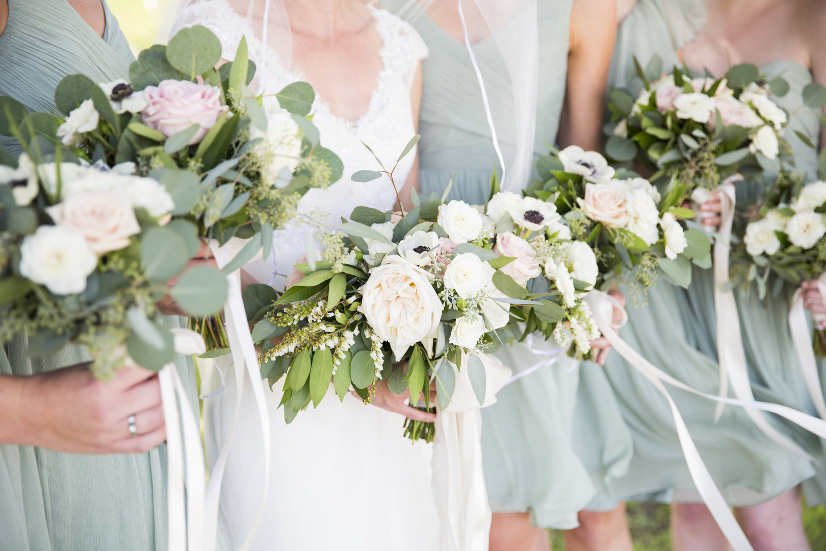 Bride and bridesmaids holding lush garden bouquets