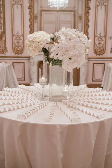 Elegant escort card table with white orchid arrangements at Fairmont San Francisco