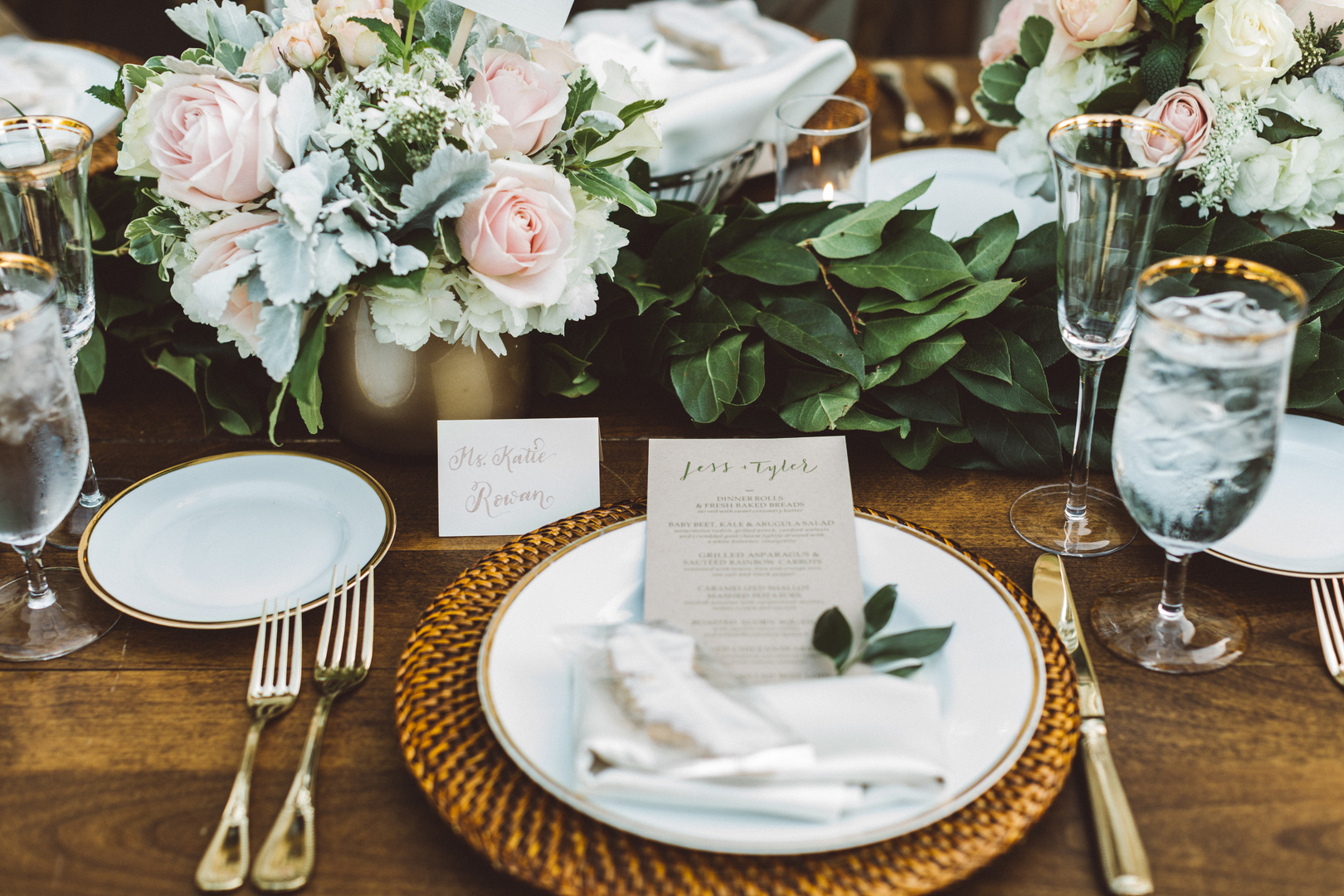 Elegant place setting with blush roses and gold-rimmed glassware